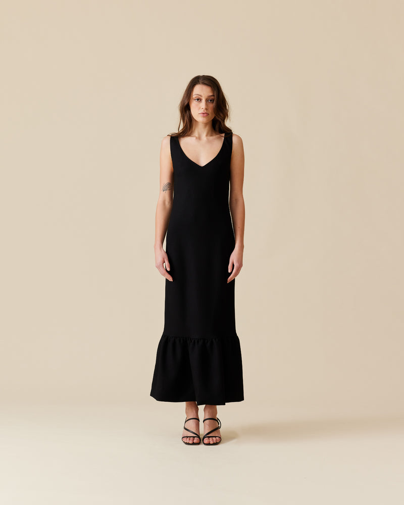 ROBIN PUFF DRESS BLACK | Slim fit bias maxi dress in with puff hem. This dress has a low, V-neckline and is sleeveless, with straps wide enough to cover bra straps.