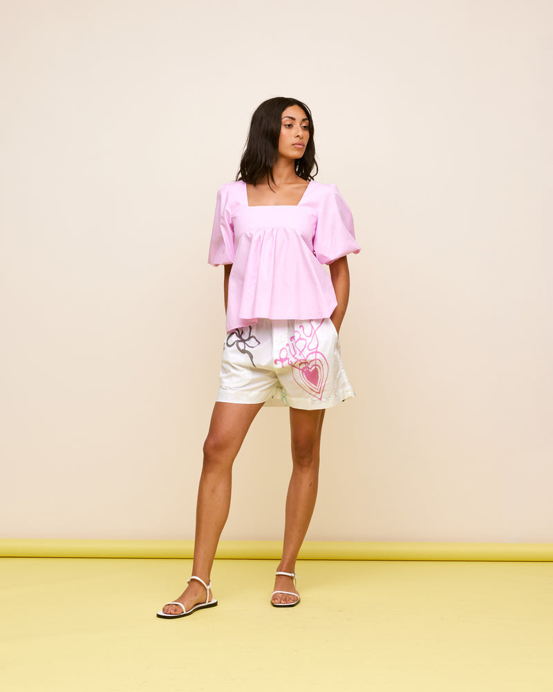 MARGIE TIE-BACK BLOUSE PINK | Cotton puff sleeve top with a square band at the bust. Features a bow tie detail at the back and a cut-out, the cutest top worn with your favourite denim.