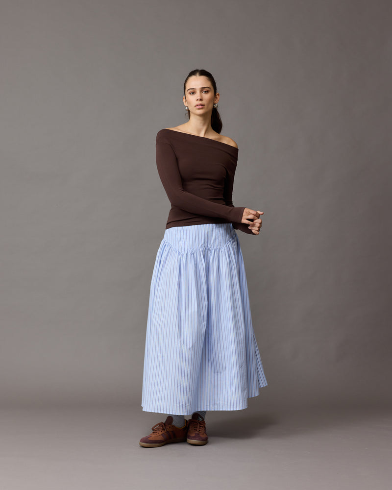 TRULLI SKIRT BLUE SKY STRIPE | Floaty basque style maxi skirt imagined in a blue stripe cotton. This skirt features a dropped bodice style waistline, that falls to a full, wide skirt.