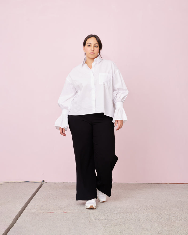 COMET SHIRT WHITE | Boxy shaped shirt that sits longer through the back with fluted cuff detailing cut in a crisp white cotton. Designed to be a stand out, the fabric of this shirt emphasises...