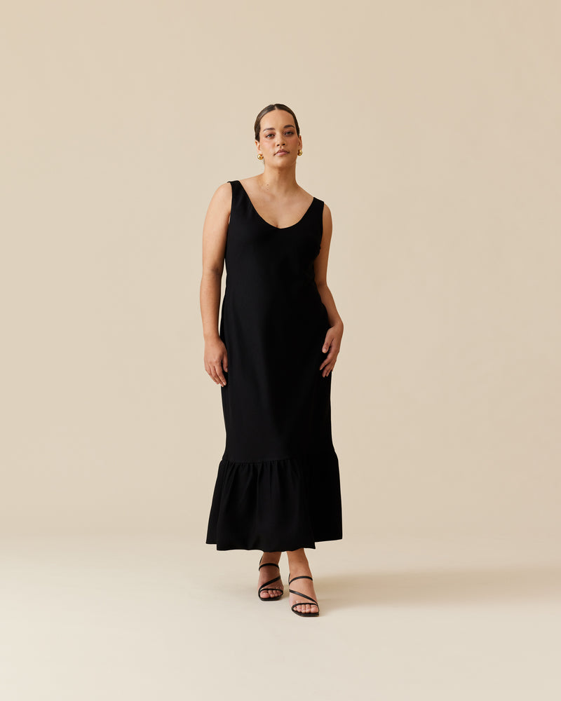 ROBIN PUFF DRESS BLACK | Slim fit bias maxi dress in with puff hem. This dress has a low, V-neckline and is sleeveless, with straps wide enough to cover bra straps.