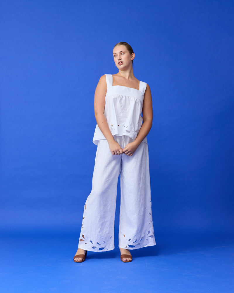 ANDIE LINEN PANT WHITE EMBROIDERY | Palazzo style elastic waist pants with a tie, in a light cotton with a feature broderie cut-outs at the hems. These pants are high waisted, uncomplicated, and classically cool. Make...