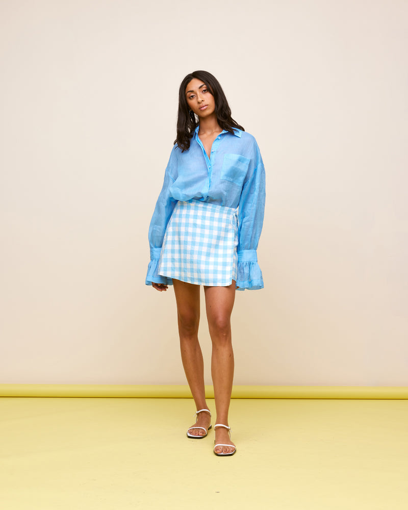 VIDA LINEN MINI SKIRT BLUE LINEN GINGHAM | Linen wrap mini skirt designed in a blue and white gingham. This skirt is versatile in that it can be worn high or low waisted.