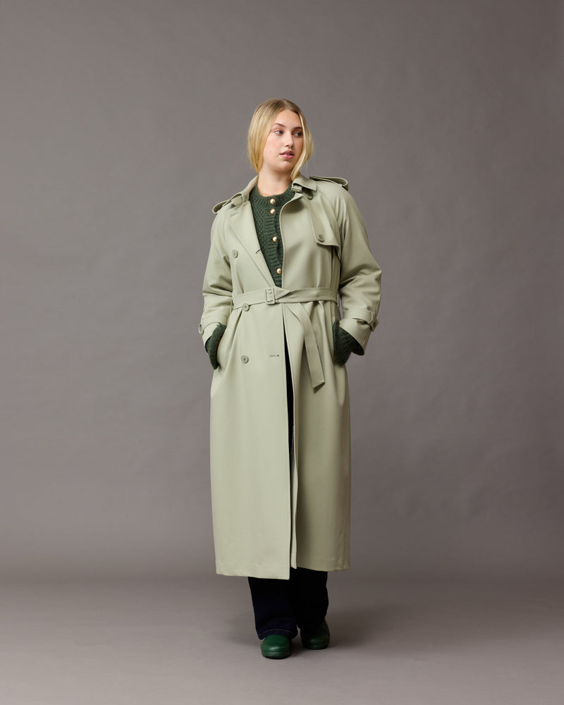 ANNIE TRENCH COAT SAGE | Oversized midi-length trench with a self-fabric belt, button fastenings and, epaulettes at the shoulders and the sleeve. A classic shape imagined in mid-weight sage coloured fabric.