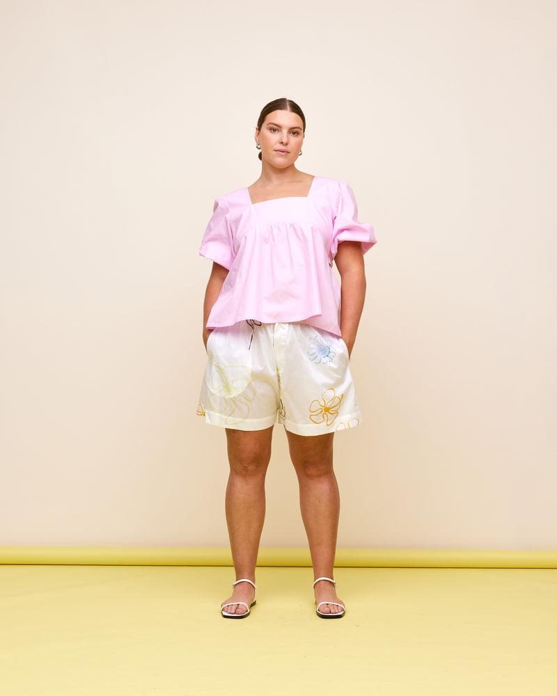 MARGIE TIE-BACK BLOUSE PINK | Cotton puff sleeve top with a square band at the bust. Features a bow tie detail at the back and a cut-out, the cutest top worn with your favourite denim.