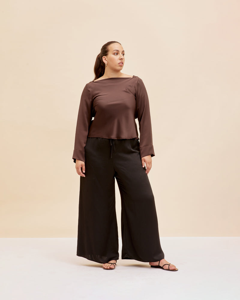 FIREBIRD SATIN COWL TOP ESPRESSO | Longsleeve blouse with a cowl neck scoop back, crafted in sleek espresso coloured satin. A minimal silhouette with an unexpected detail in the draped back neck and a tie to...