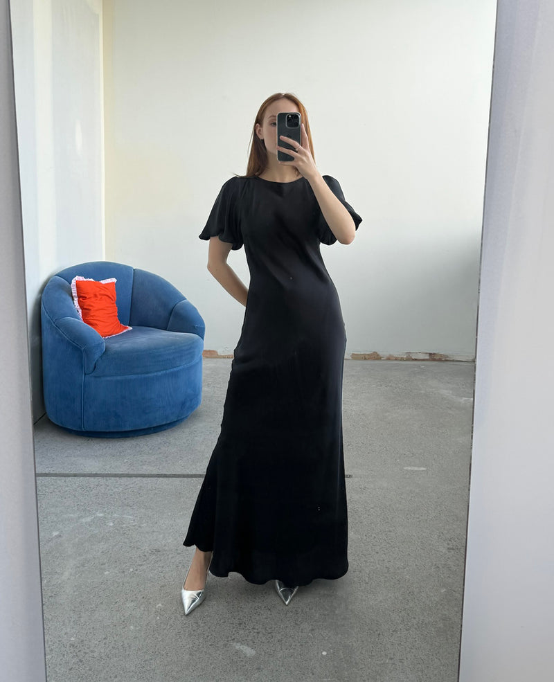 KENDALL SATIN DRESS BLACK | Bias cut satin midi dress with puff sleeves and a keyhole button closure at the back neck. The bias silhouette of this dress gently contours the body, while the satin...