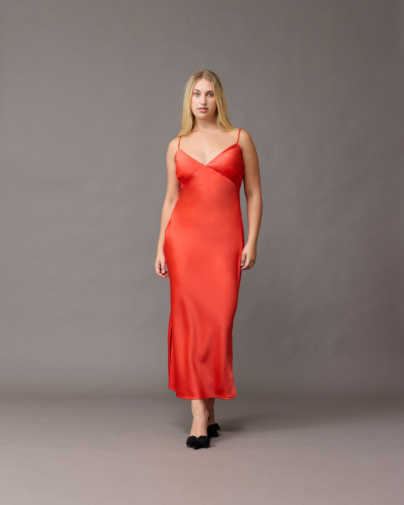 WEIRDLY SLIP VERMILLION | Iconic bias cut slip dress with plunging neckline in a longer length. A wardrobe staple in heavy-weight double satin that is lush to wear, in a sheeny vermillion colour.