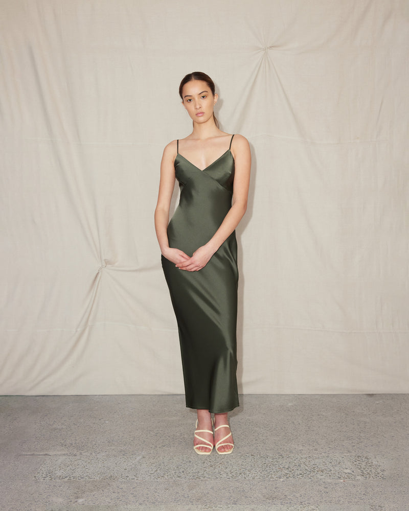 WEIRDLY SLIP JETTA GREEN | Iconic bias cut slip dress with plunging neckline in a new longer length. A wardrobe staple in heavy weight double satin that is lush to wear, in a rich jetta green colour.