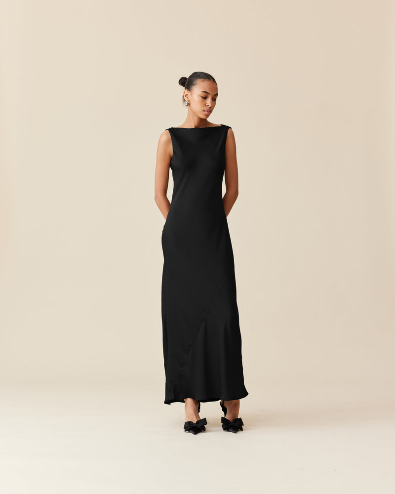 FIREBIRD COWL GOWN BLACK | Sleeveless midi dress crafted in luxe black satin. Features a minimal silhouette with a cowl back detail and a tie to cinch in the waist.
