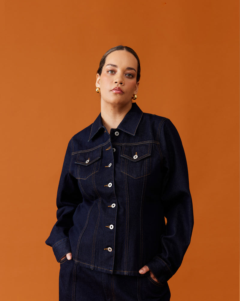 MADELEINE DENIM JACKET UNWASHED | Fitted denim shirt jacket designed in a raw denim. Features panelling with contrast stitching, and 2 front pockets. Pairs as a set with the Madeleine Denim Mini Skirt.
