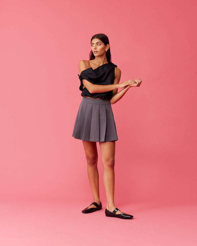 CARMY MINI SKIRT CHARCOAL | Pleated mini skirt designed in a suiting fabric. Cute and to the point, this skirt will become a wardrobe staple.