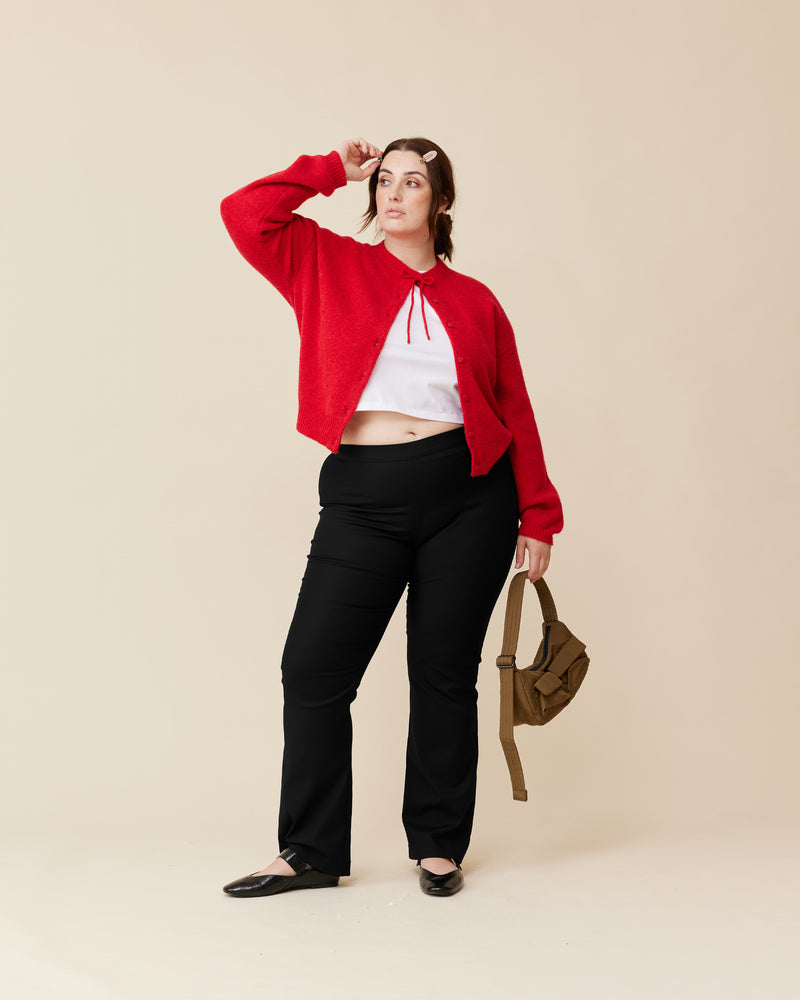 ANNIE CARDIGAN CHERRY RED | Crew neck cardigan with a button-down front, designed in a cosy alpaca wool blend. This cardigan comes with a detachable bow-tie, to style on the cardigan through the buttonhole, in...