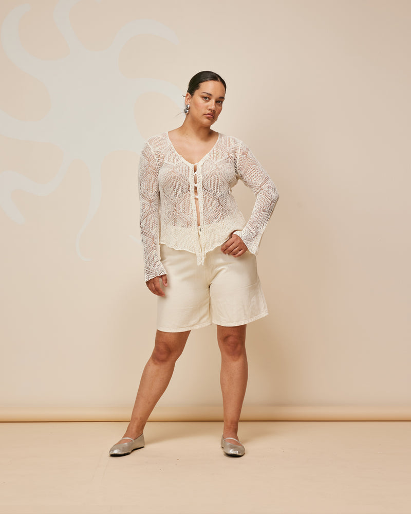 DANI CARDIGAN CREAM | Longsleeve pointelle lace cardigan with a handkerchief hemline. Knitted in a luxe cotton-linen blend, this top is the perfect summer-weight knit.