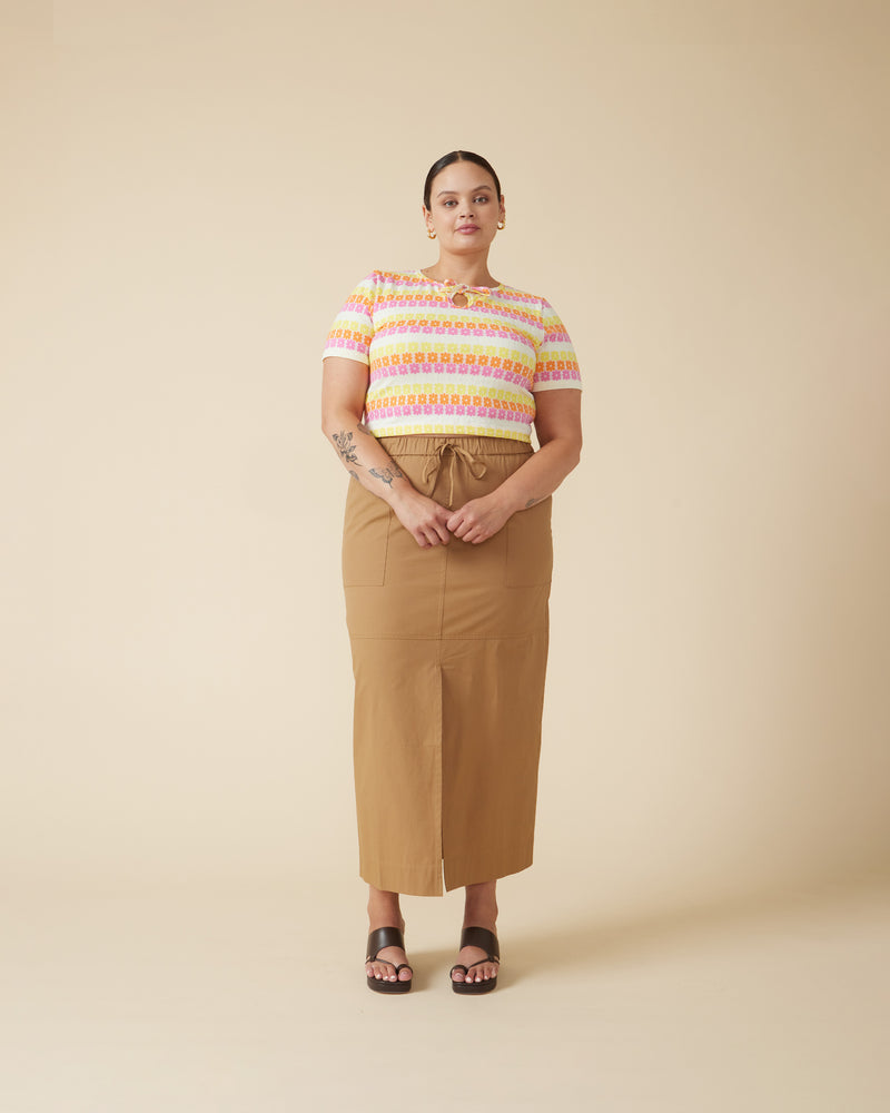 FAI SKIRT TAN | Cargo-style midi skirt with a front split, designed in a camel coloured cotton. Panel stitch detailing creates a relaxed look while the elastic waistband ensures an easy, comfortable fit.