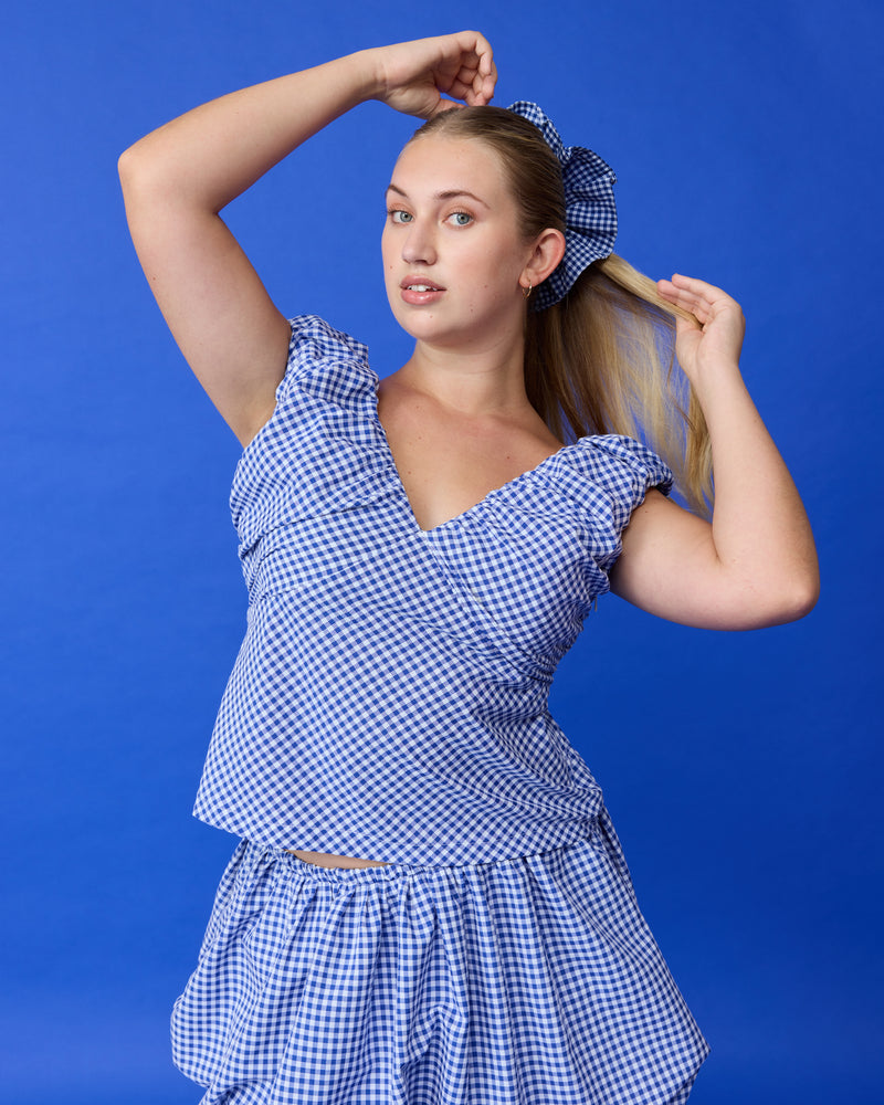 RAQUEL TOP COBALT GINGHAM | Crafted in a cobalt gingham fabric with ruched detailing at the bust, this top can be worn on or off the shoulder. The tailored fit is designed to sit close...