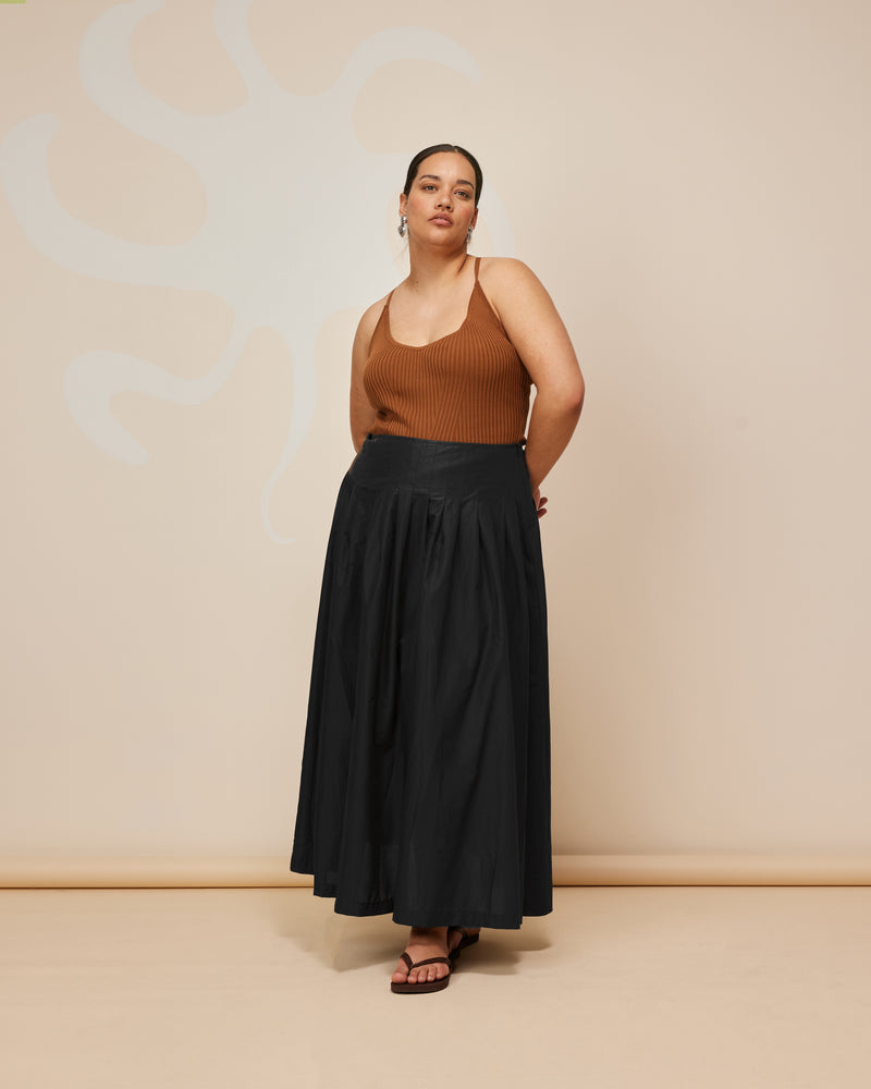 SANDLER SKIRT BLACK | Tennis style maxi skirt with a pleated drop waist. Designed in a soft, black cotton, this skirt is floaty when you walk and is cool to wear.