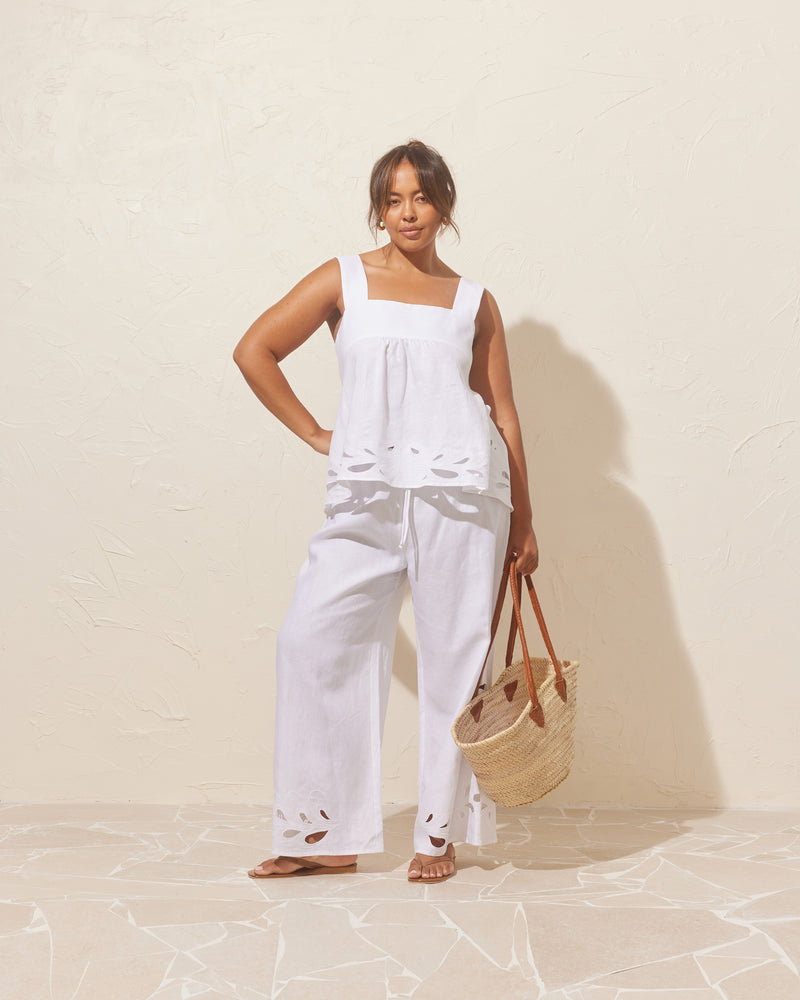 ANDIE LINEN PANT WHITE EMBROIDERY | Palazzo style elastic waist pants with a tie, in a light cotton with a feature broderie cut-outs at the hems. These pants are high waisted, uncomplicated, and classically cool. Make...