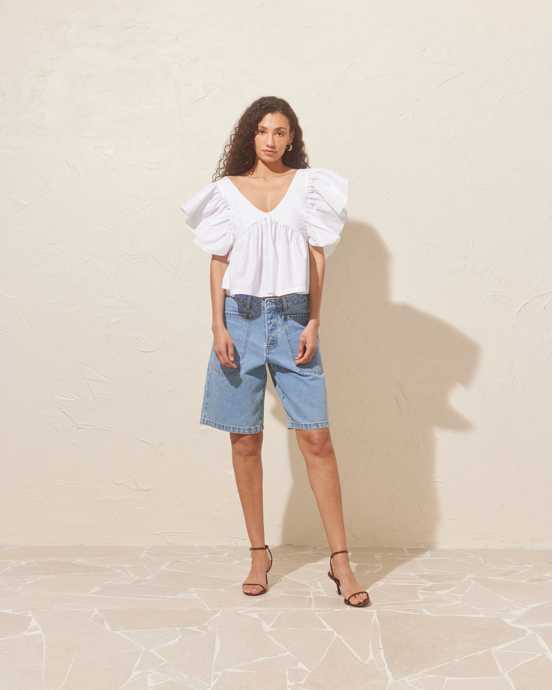 MERCI DENIM SHORT LIGHT BLUE | Long-line denim short designed in a light blue washed denim. These shorts have large feature pockets which add to the baggy, cargo style.