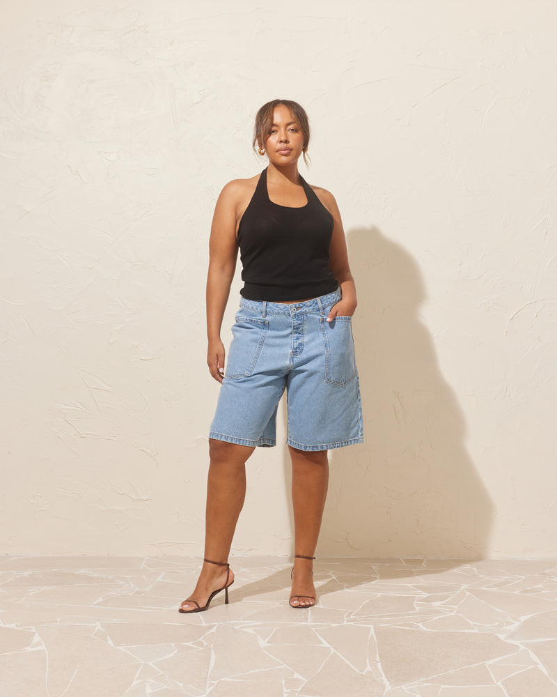 MERCI DENIM SHORT LIGHT BLUE | Long-line denim short designed in a light blue washed denim. These shorts have large feature pockets which add to the baggy, cargo style.