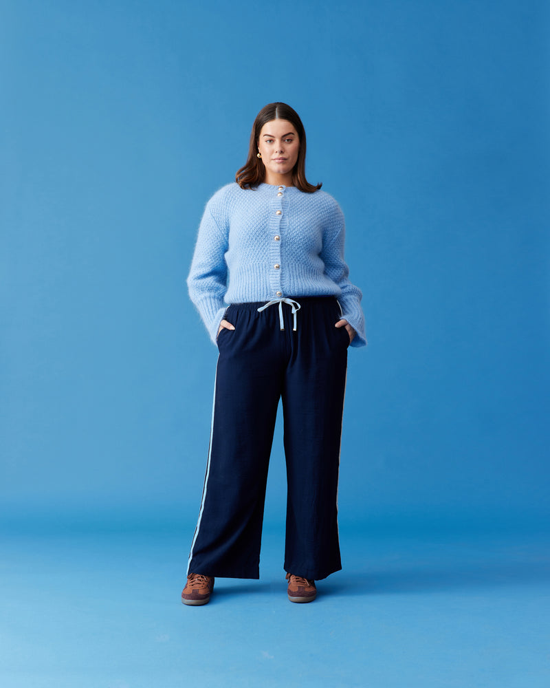 MATILDA CARDIGAN SKY BLUE | Button-down cardigan with gold metallic dome buttons and a slightly puff-shouldered silhouette. Features an exaggerated flute cuff crafted in a chunky mohair and wool blend.