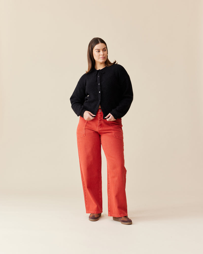 ANNIE CARDIGAN BLACK | Crew neck cardigan with a button-down front, designed in a cosy alpaca wool blend. This cardigan comes with a detachable bow-tie, to style on the cardigan through the buttonhole, in...