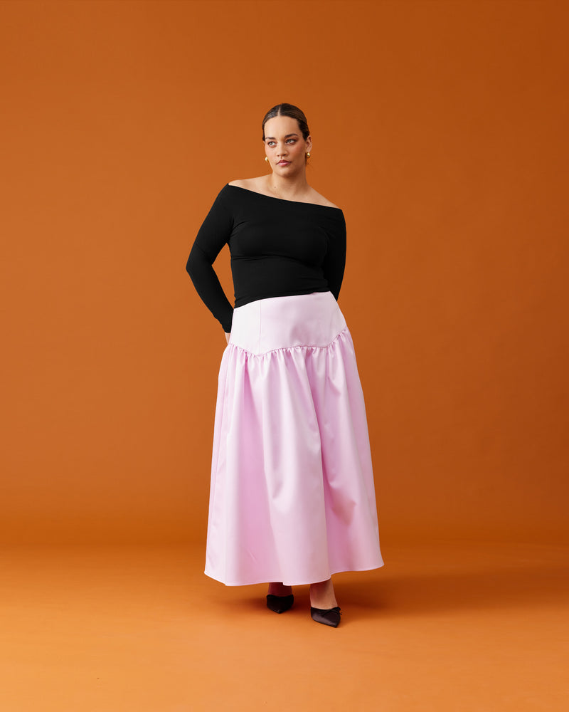 TRULLI SATIN SKIRT SOFT PINK | Floaty basque style maxi skirt imagined in a soft pink satin. This skirt features a bodice-style waistline, that falls to a full, wide skirt.
