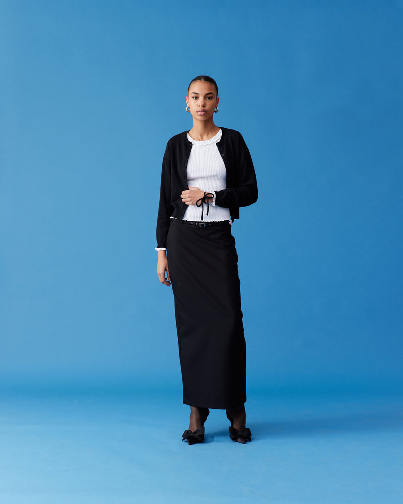 EMMA CARDIGAN BLACK | Crew neck cardigan with a button-down front, designed in luxe viscose knit. This cardigan comes with a detachable bow-tie, to style on the cardigan through the buttonhole, in your hair,...