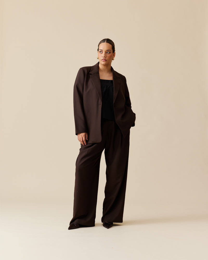 RUE TROUSER JAVA | Straight-leg mid-waist suit trouser with a flat waistband and belt loops. These pants are versatile in that they can be worn casual with a baby tee, or formal with the...