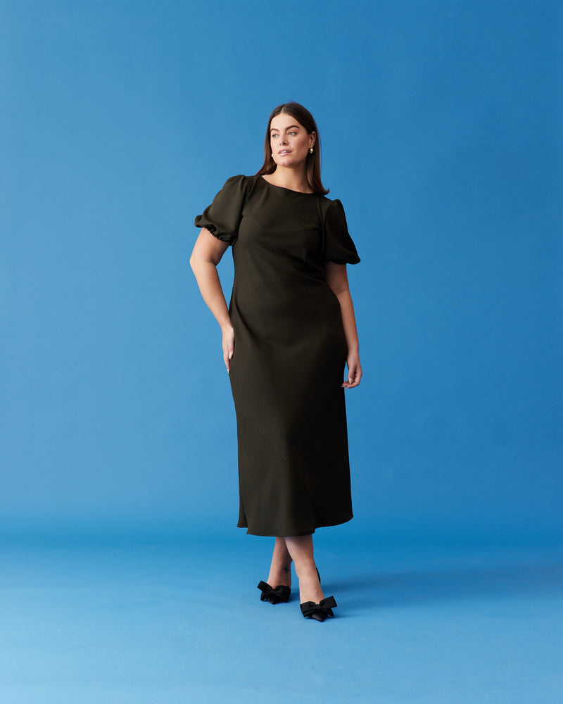 NINETTE DRESS KHAKI | An update on our much-loved Rubette favourite Kendall Dress, this is a bias-cut dress with a subtle puff sleeve and cut-out back. Cut from a soft khaki viscose, this piece...