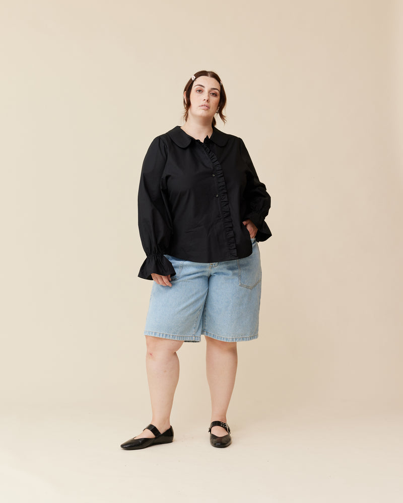 SANDLER RUFFLE SHIRT BLACK | Long sleeve black shirt with ruffles down the placket and a rounded collar. This top features elasticated ruffle cuffs, this piece is an elevated take on the classic shirt shape.