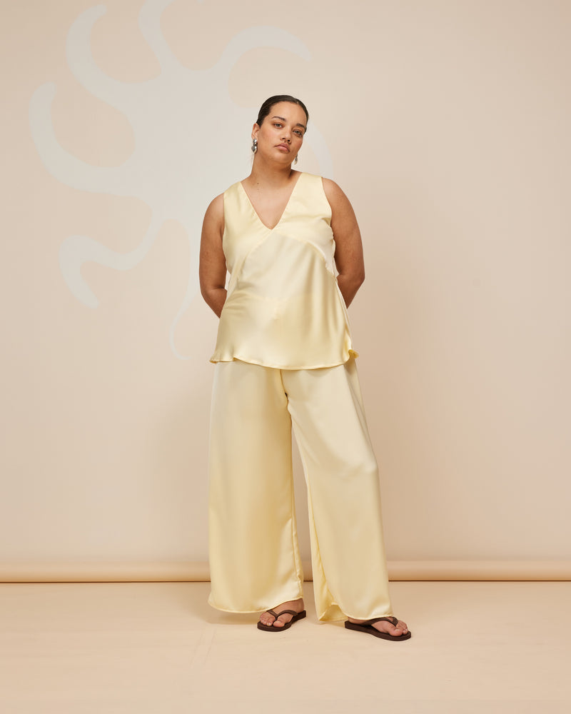 ANDIE SATIN PANT BUTTER | Palazzo style elastic waist pants with a tie, in a luxurious butter coloured satin. These pants are high waisted, uncomplicated and classically cool.