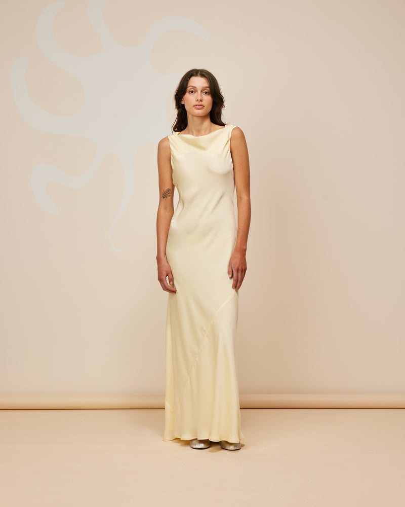 FIREBIRD COWL GOWN BUTTER | Sleeveless midi dress crafted in rich butter satin. Features a minimal silhouette with a cowl back detail and a tie to cinch in the waist.