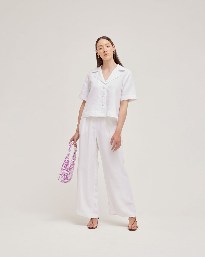 LAFAYETTE PANT WHITE | Highwaisted wide leg suit pant with front tucks to add fullness. Tailored from a soft white cupro, these pleated pants have a sweeping wide leg silhouette.