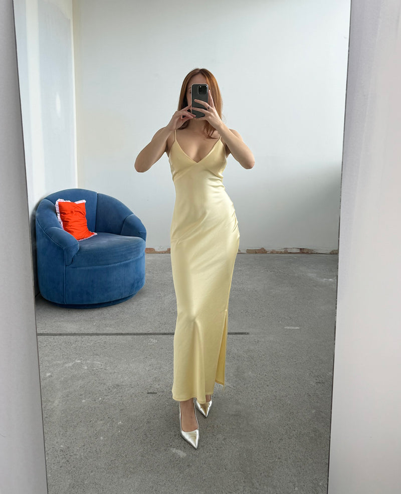 WEIRDLY SLIP BUTTER | Iconic bias cut slip dress with plunging neckline in a new longer length. A wardrobe staple in heavy weight double satin that is lush to wear, in a sheeny butter....