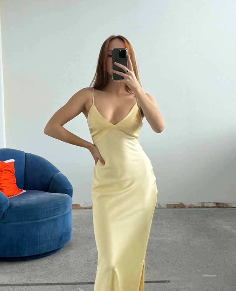 WEIRDLY SLIP BUTTER | Iconic bias cut slip dress with plunging neckline in a new longer length. A wardrobe staple in heavy weight double satin that is lush to wear, in a sheeny butter....