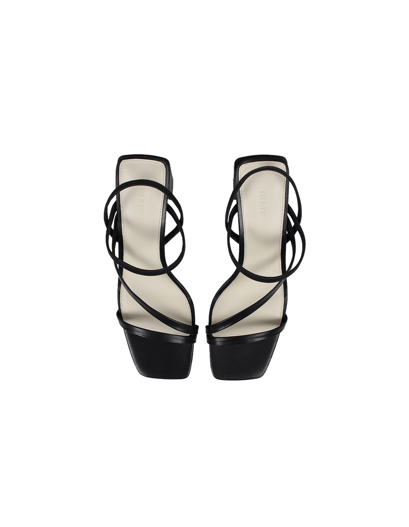 TIA HEEL BLACK | Square toe heel with straps around the ankle and across the front of the foot. A square block heel adds height but makes these shoes sturdy, while the ankle strap...